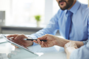 Two people collaborating with tablet