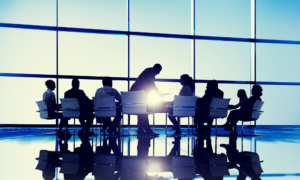 Executives meeting in conference room around table